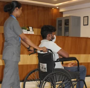 female nurse pushing a male patient in wheelchair